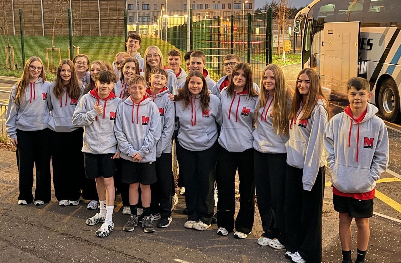 Monifieth swimmers together in club hoodies before a team trip